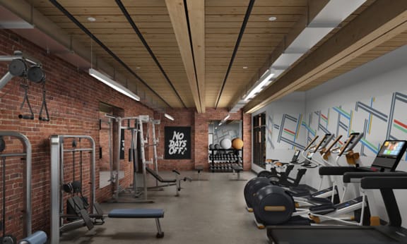 a gym with a brick wall and wood ceiling