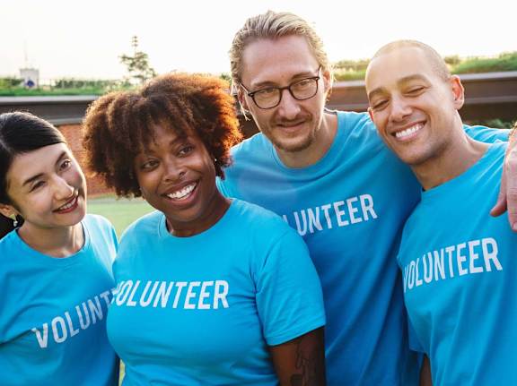 a group of people wearing blue volunteer shirts