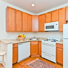 a kitchen with white appliances and wooden cabinets