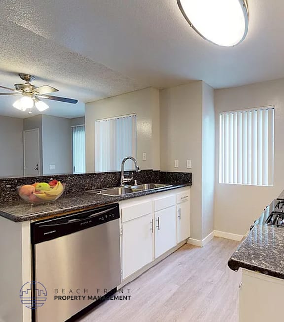 A well-lit, modern kitchen and living room with a dining area.