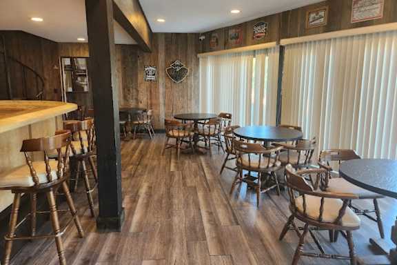 a dining room with tables and chairs and a bar