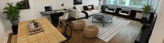 a living room with a wooden floor and a couch and a table