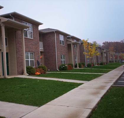 Apartment building with a walkway in front.