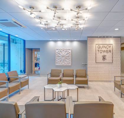 a waiting room at a hospital with chairs and a table at Quincy Tower Apartments in Boston, MA 02116