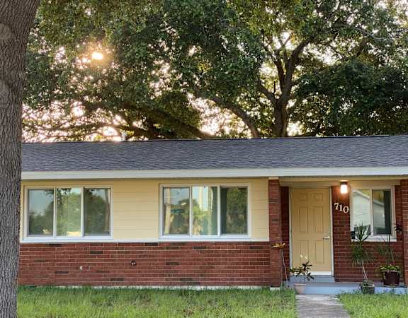 A house with a brown door and a small porch.