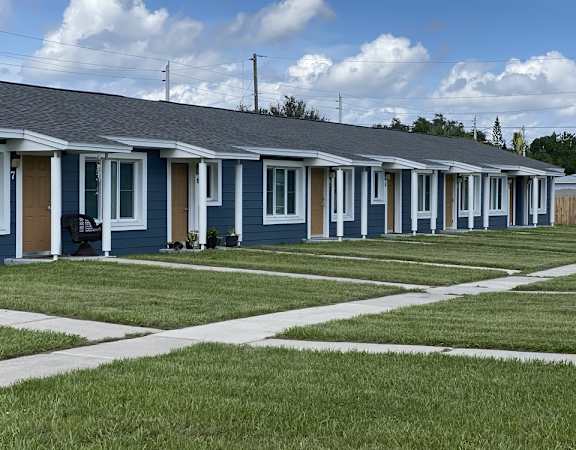 A row of houses with blue siding and white trim.
