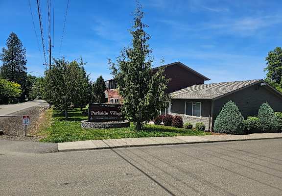 A sign in front of a house reads "Parkside Villas".