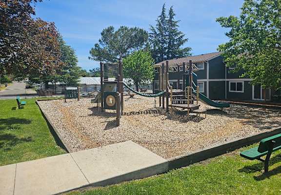 A playground with a swing set and a slide.