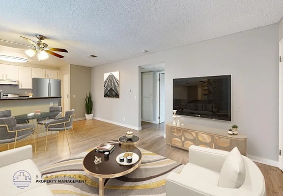 A living room with a television, a sofa, and a coffee table.