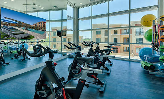 a gym with lots of exercise bikes and a large window at 56 North, Phoenix, 85054