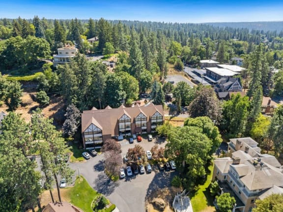 a view from above of a house surrounded by trees and buildings