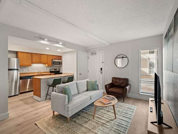 A living room with a couch, chair, and a coffee table.