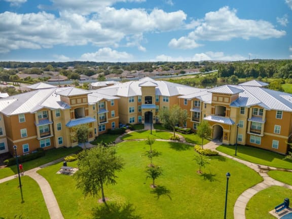 an aerial view of an apartment complex with a green yard