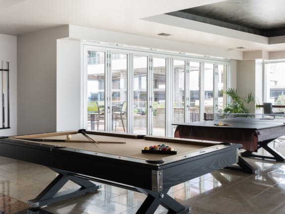 A game room with a pool table at The Heights at Park Lane, Texas, 75231
