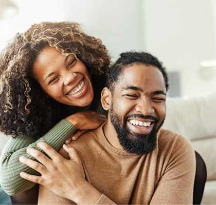 A man and woman are embracing each other in a warm hug.
