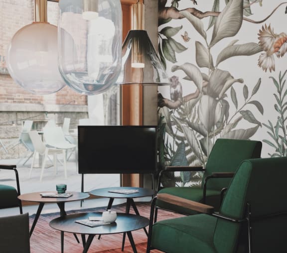 a room with green chairs and a television