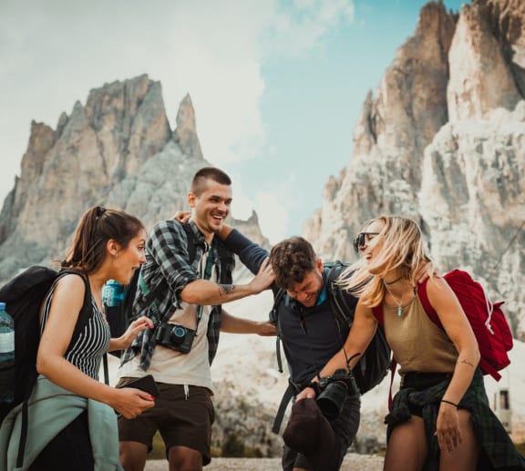 a group of people standing in front of a mountain