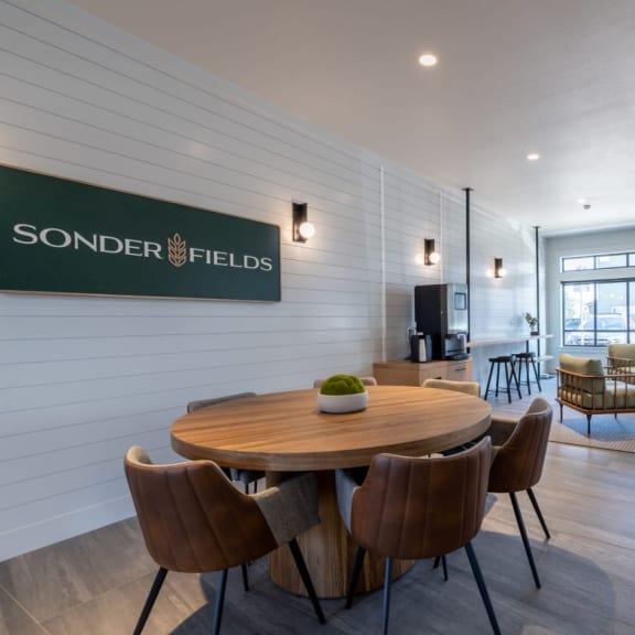 a dining room with a wooden table and chairs at Sonder Fields in Happy Valley, OR