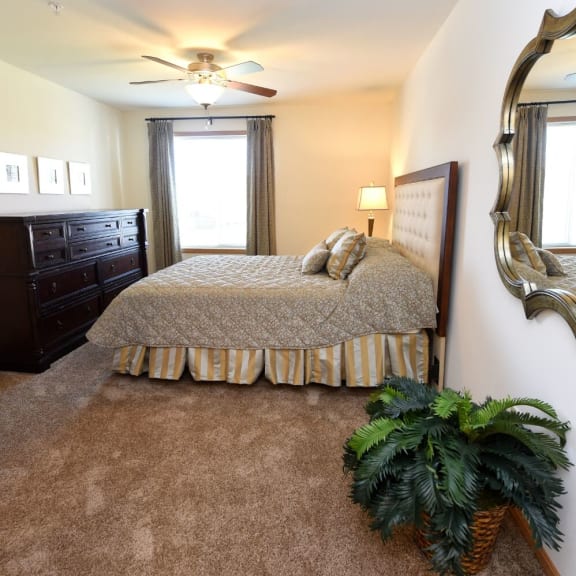 a bedroom with a bed and a ceiling fan