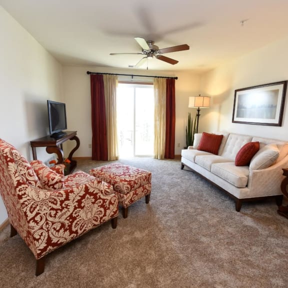 a living room with a couch and a chair and a tv