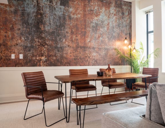 A living room with a brown table and chairs. at Market Square Place, Pittsburgh, PA, 15222
