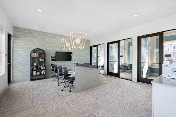 A modern office with a grey stone wall and a grey reception desk.  at The Quinn Luxury Apartments, Pensacola, FL