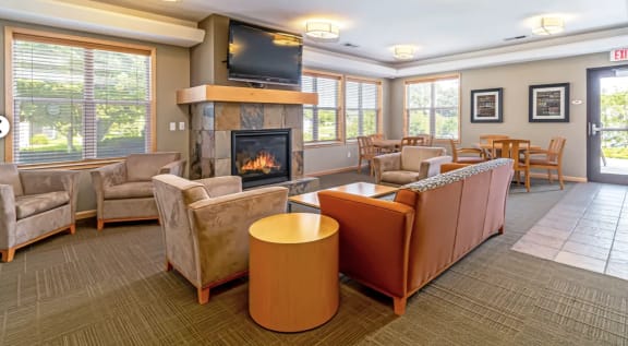 a living room with couches and chairs and a fireplace