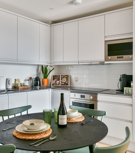 a kitchen and dining area with a table and chairs