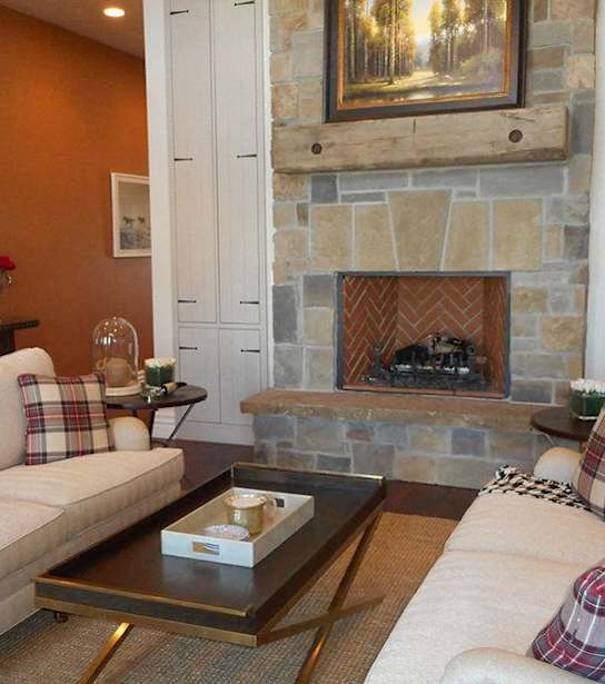 A living room with a fireplace and two couches.