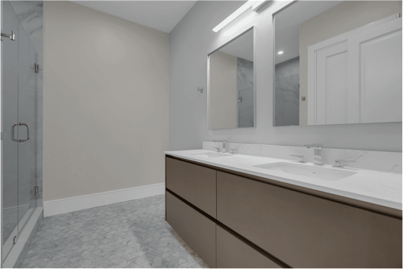 a bathroom with a sink and mirror and a shower