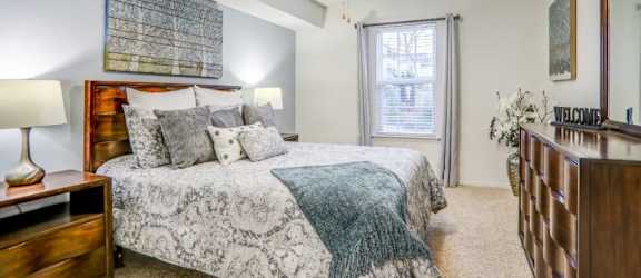 a bedroom with a bed and a ceiling fan