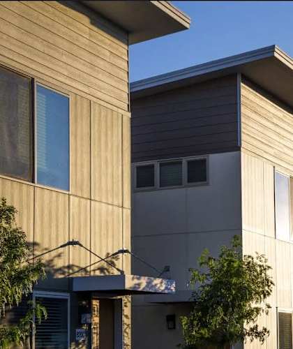 the exterior of a house with wood siding and a balcony