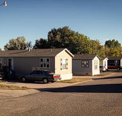 a row of houses with cars parked in front of them at West Winds in Cheyenne, WY