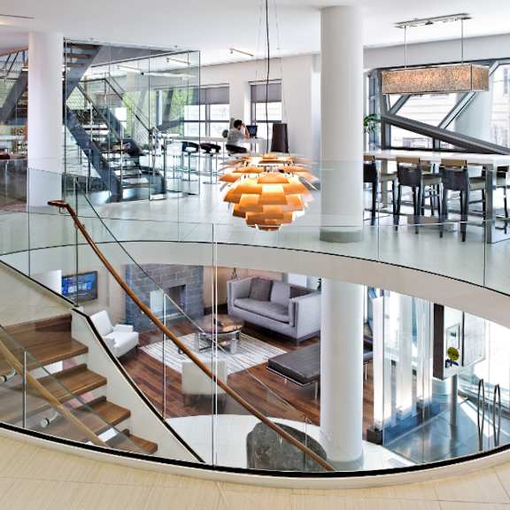 the lobby of a building with a glass staircase