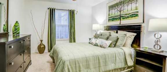 a bedroom with a bed and a ceiling fan