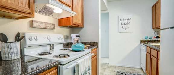 a kitchen with a stove top oven next to a sink