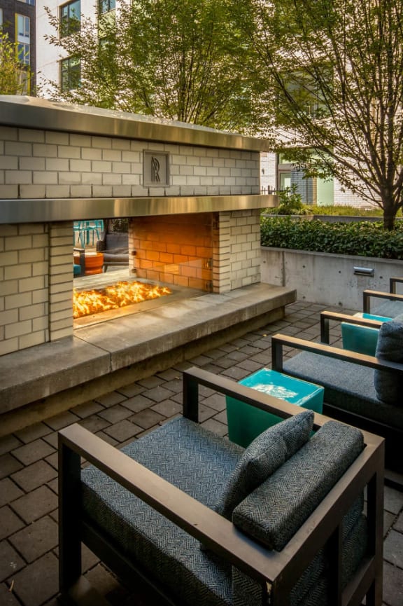 a patio with furniture and an outdoor fireplace at The Parker in Oregon 97209