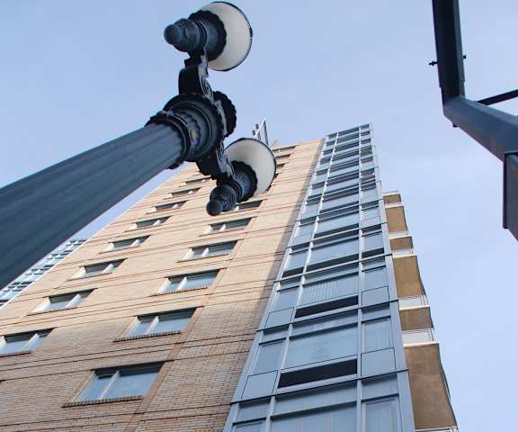 A tall building with a street light in front of it.