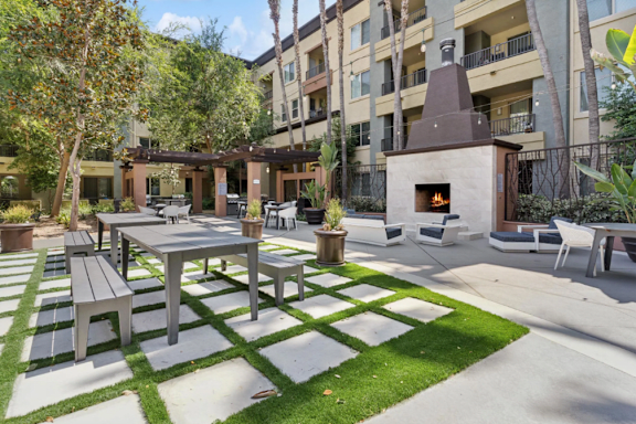 A green lawn in front of apartment buildings.