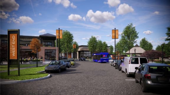 a city street with cars and a bus in front of a building