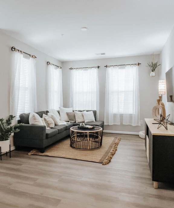 A living room with a couch, chair, and television.