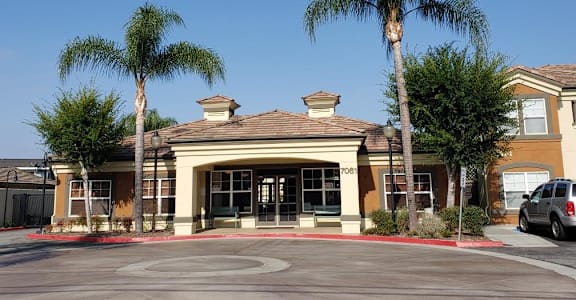 A building with palm trees in front of it.