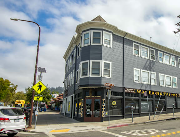 A street view of a building with the sign "War Horse Tattoos" on it.