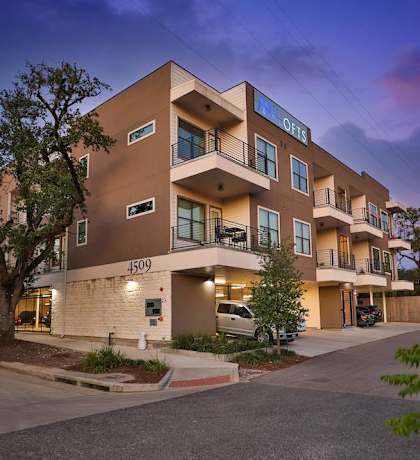 a modern apartment building with a street in front of it