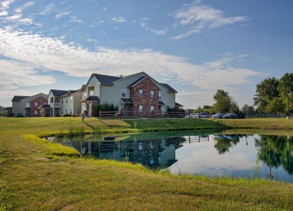 a pond in front of a house