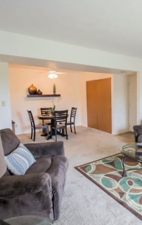 a living room and dining room with a couch and a table