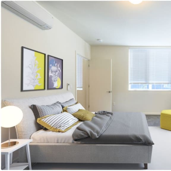 a bedroom with a bed and two windows