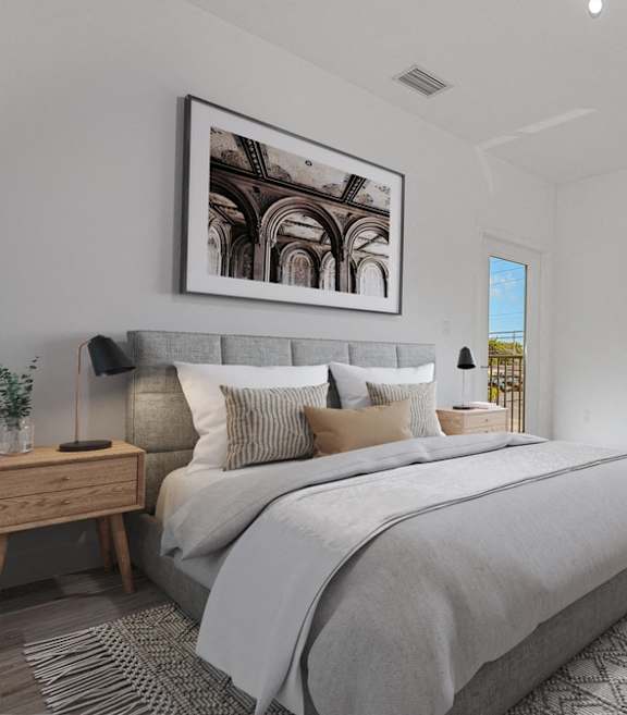 A bedroom with a large bed and a painting on the wall.