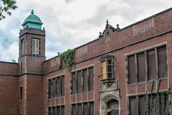 an old brick building with a tower and windows