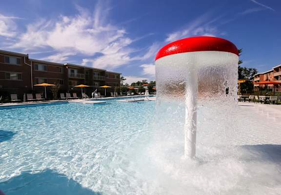 A water fountain in the middle of a pool.